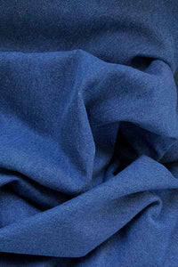 Dark blue denim jacket-constructor with orange-blue checkered crepe left sleeve close up